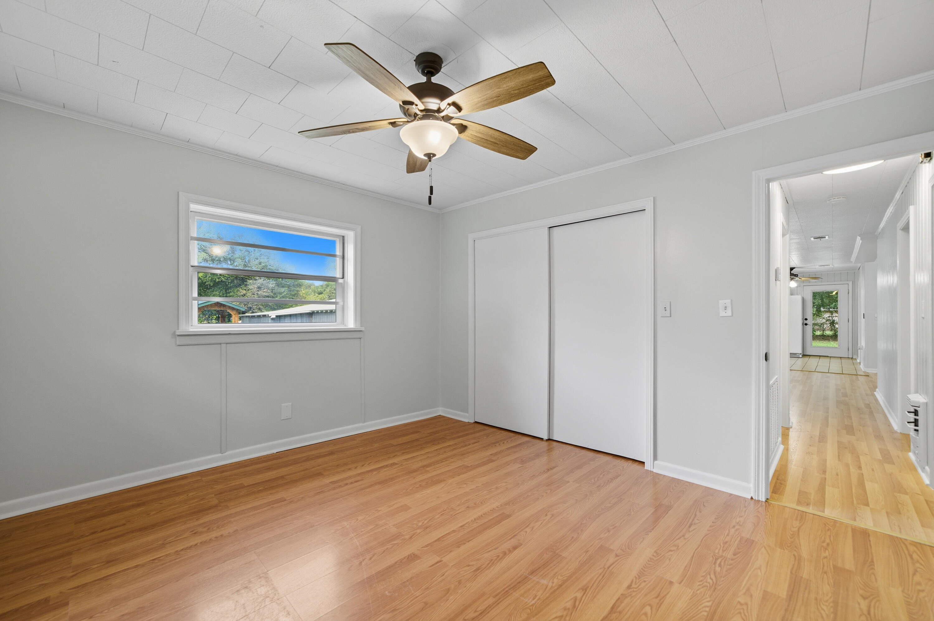 2128 3rd Avenue Crestview, FL 32539 - Photo 16 of 50 a view of a big room with wooden floor and a chandelier fan