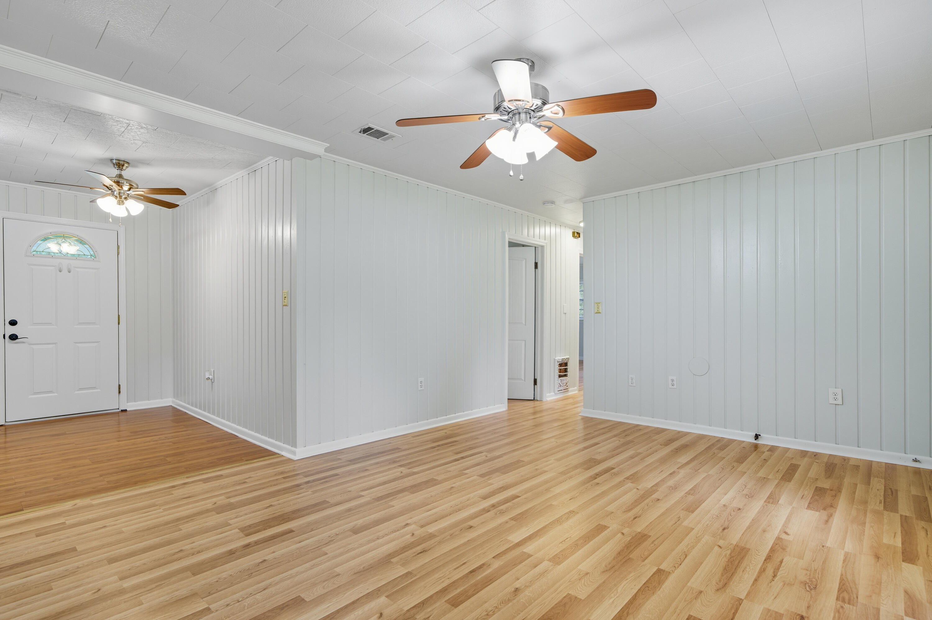 2128 3rd Avenue Crestview, FL 32539 - Photo 18 of 50 a view of an empty room with wooden floor