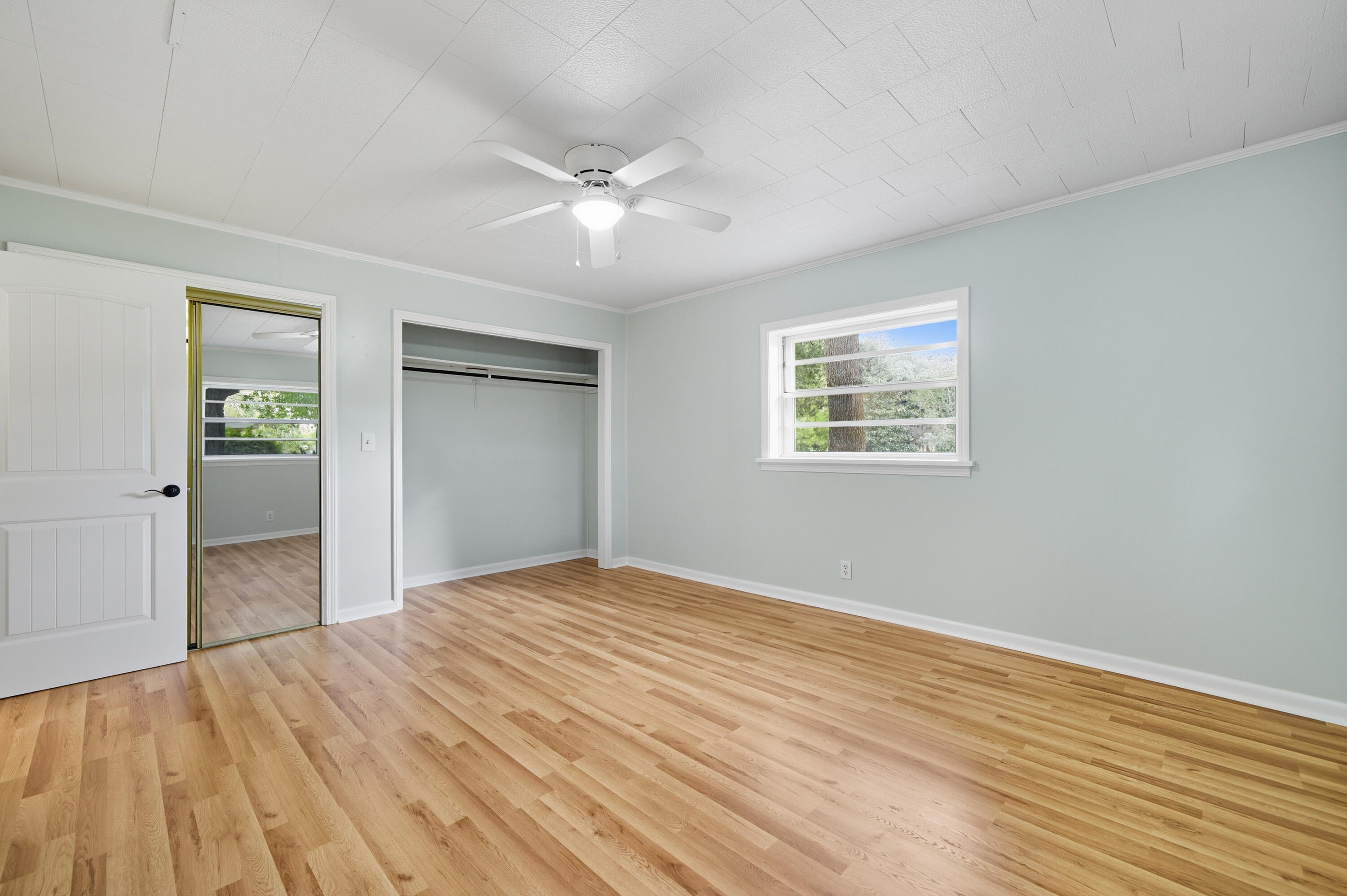 2128 3rd Avenue Crestview, FL 32539 - Photo 20 of 50 a view of an empty room with wooden floor and a window