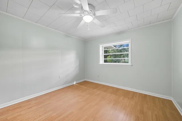 wooden floor in an empty room with a window