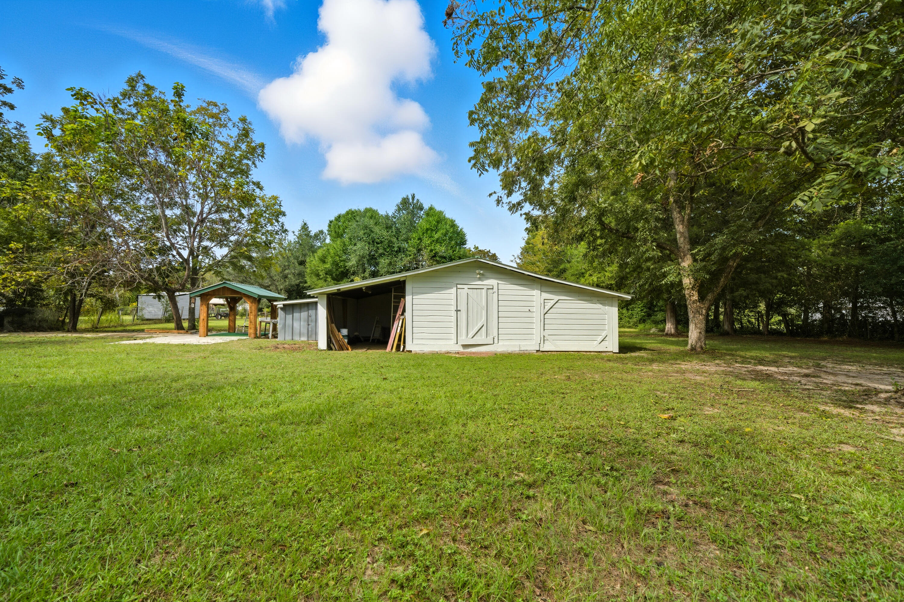 2128 3rd Avenue Crestview, FL 32539 - Photo 42 of 50 a house with huge green field in front of it