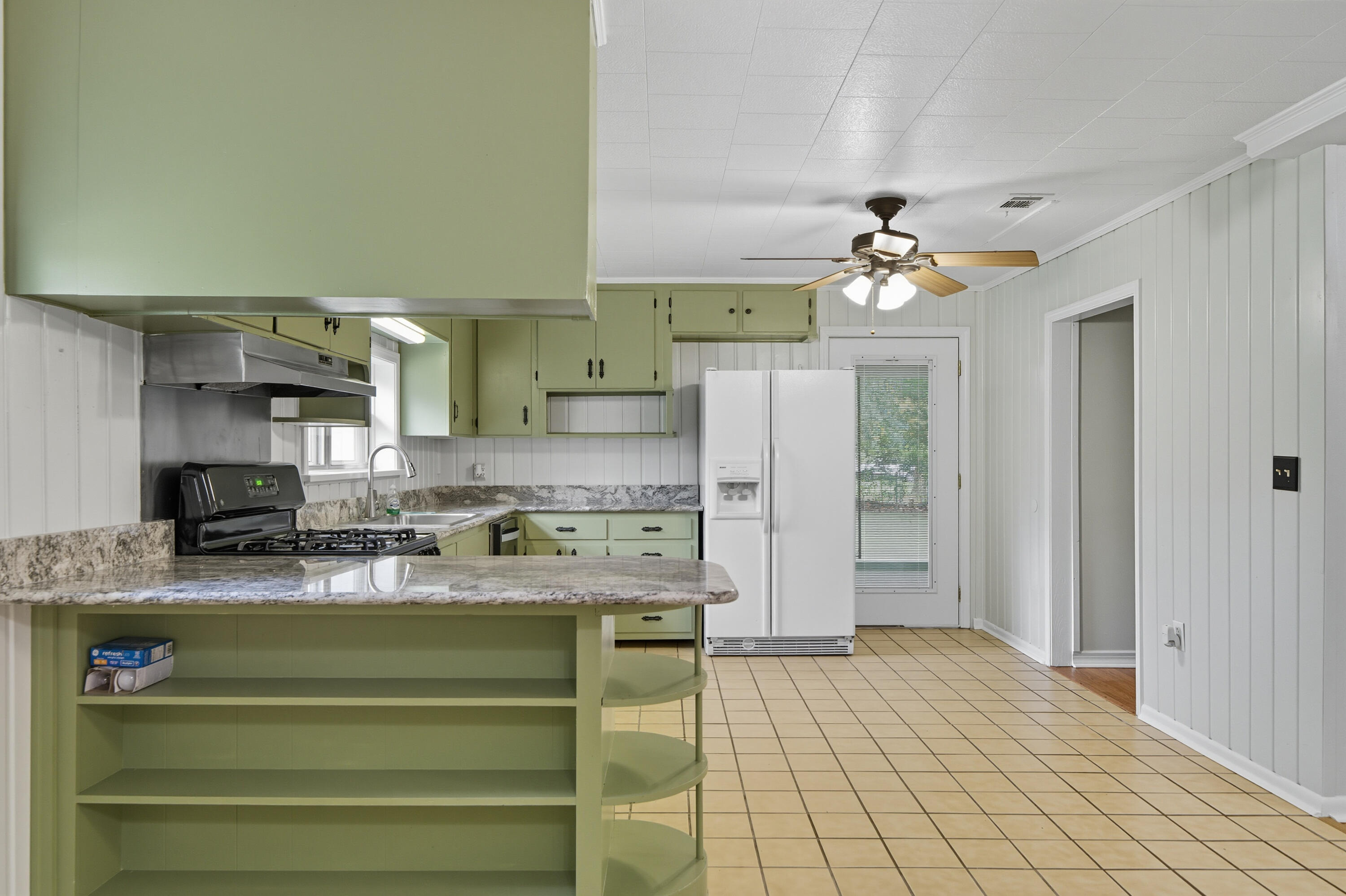 2128 3rd Avenue Crestview, FL 32539 - Photo 7 of 50 a kitchen with a refrigerator a sink and cabinets