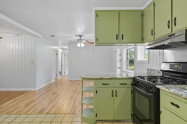 a kitchen with a cabinets a sink and appliances