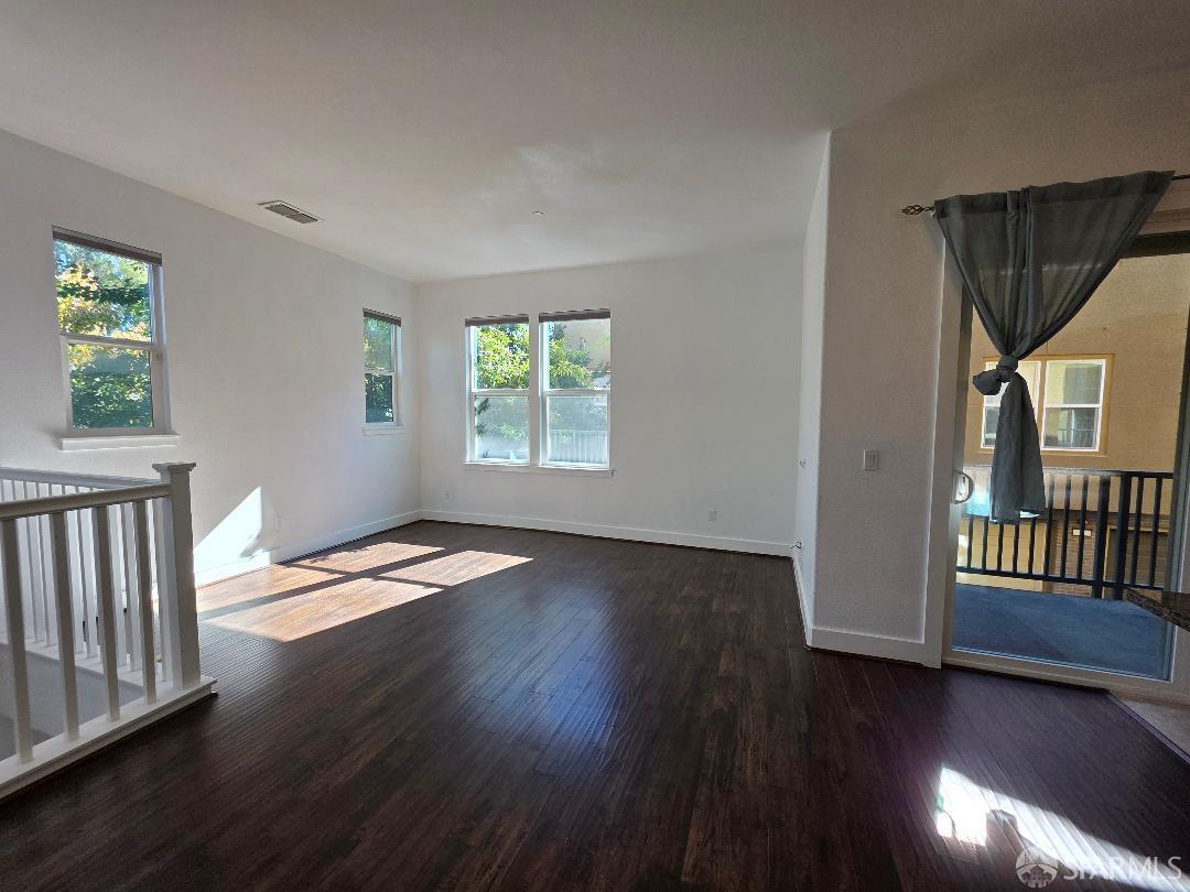 2415 Stearman Court, Unit 7 San Jose, CA 95132 - Photo 6 of 13 a view of an empty room with wooden floor and a window