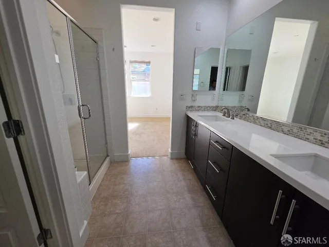 a bathroom with a double vanity sink and a mirror