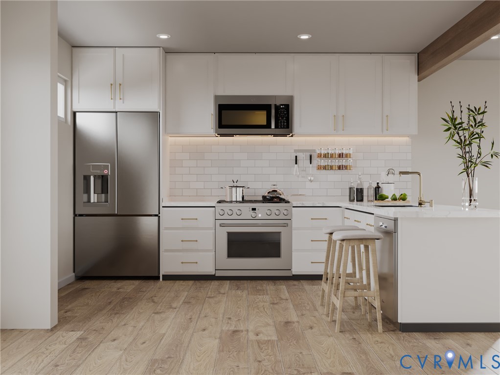 5206 Gillespie Avenue Henrico, VA 23228 - Photo 3 of 4 a kitchen with a refrigerator stove and microwave