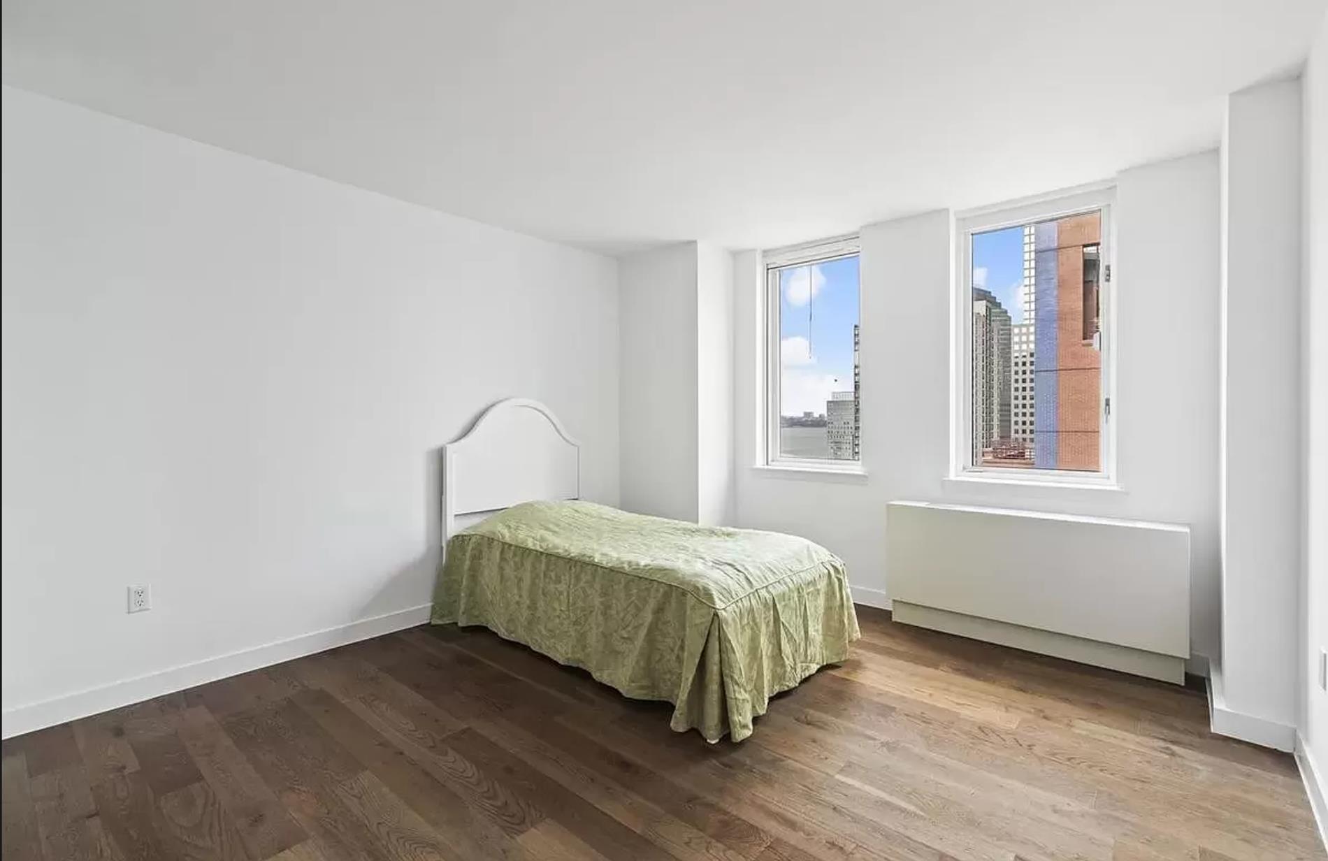 225 Rector Place, Unit 22H Manhattan, NY 10280 - Photo 3 of 13 a room with a bed and window