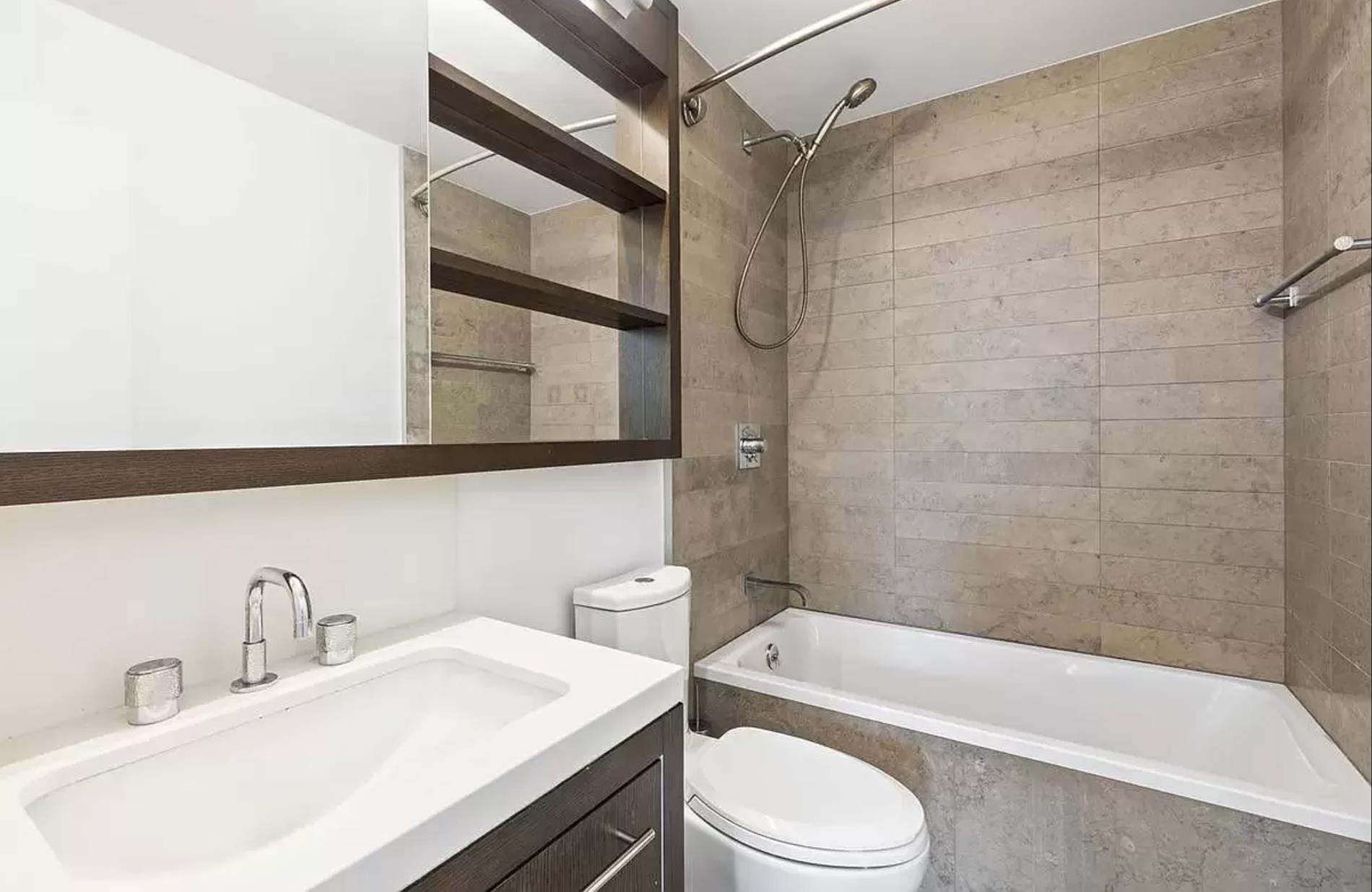 225 Rector Place, Unit 22H Manhattan, NY 10280 - Photo 6 of 13 a bathroom with a sink toilet and shower