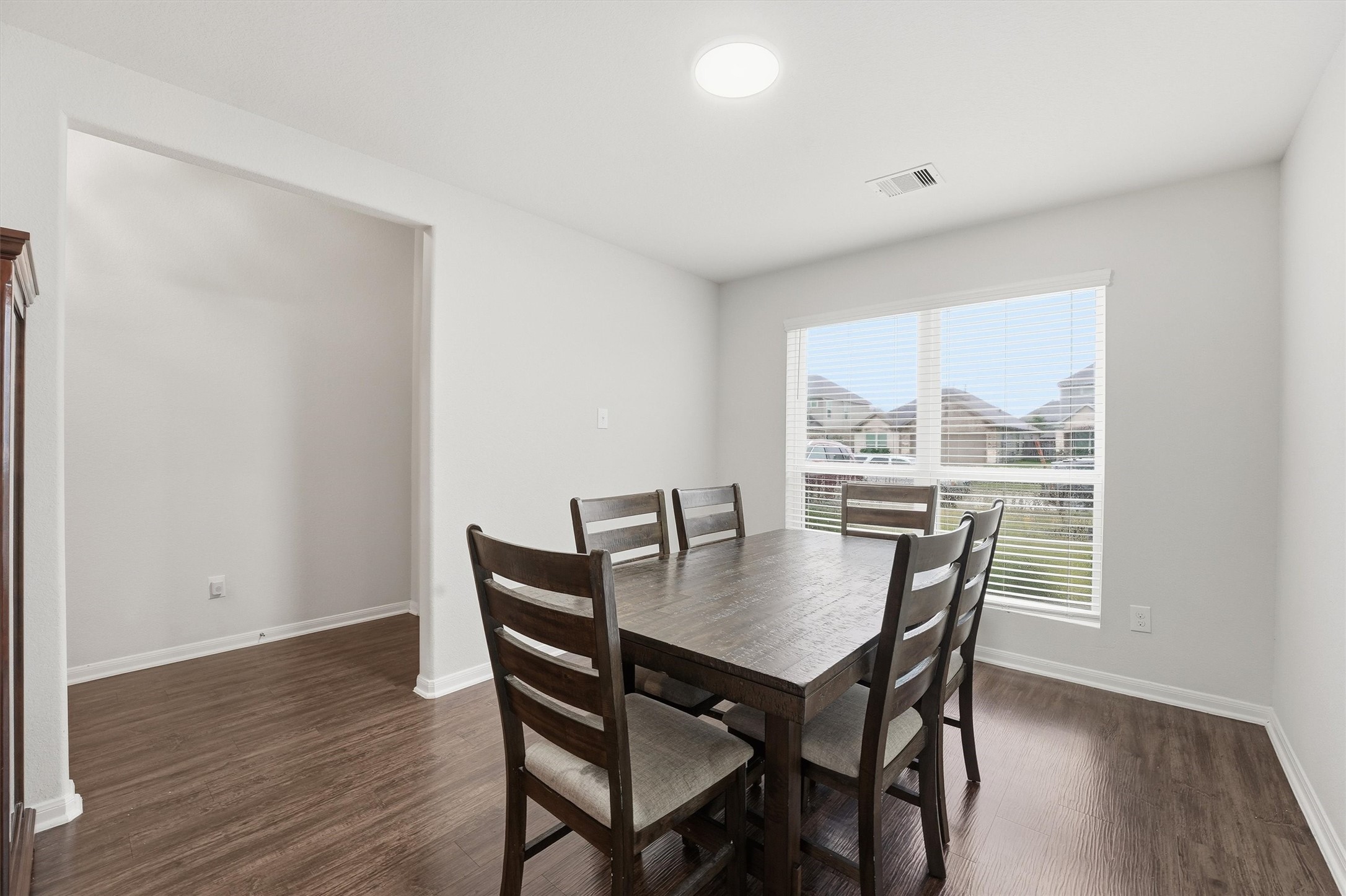 2115 Pacific Loon Lane Conroe, TX 77385 - Photo 12 of 26 a view of a dining room with furniture window and wooden floor