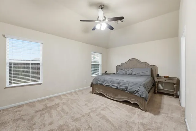 a bedroom with a bed and window