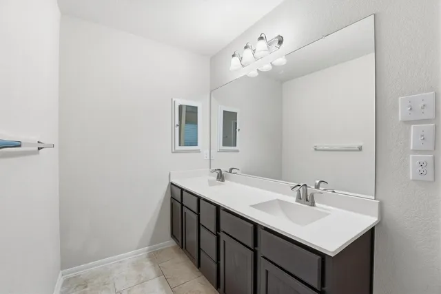 a bathroom with a sink vanity and mirror