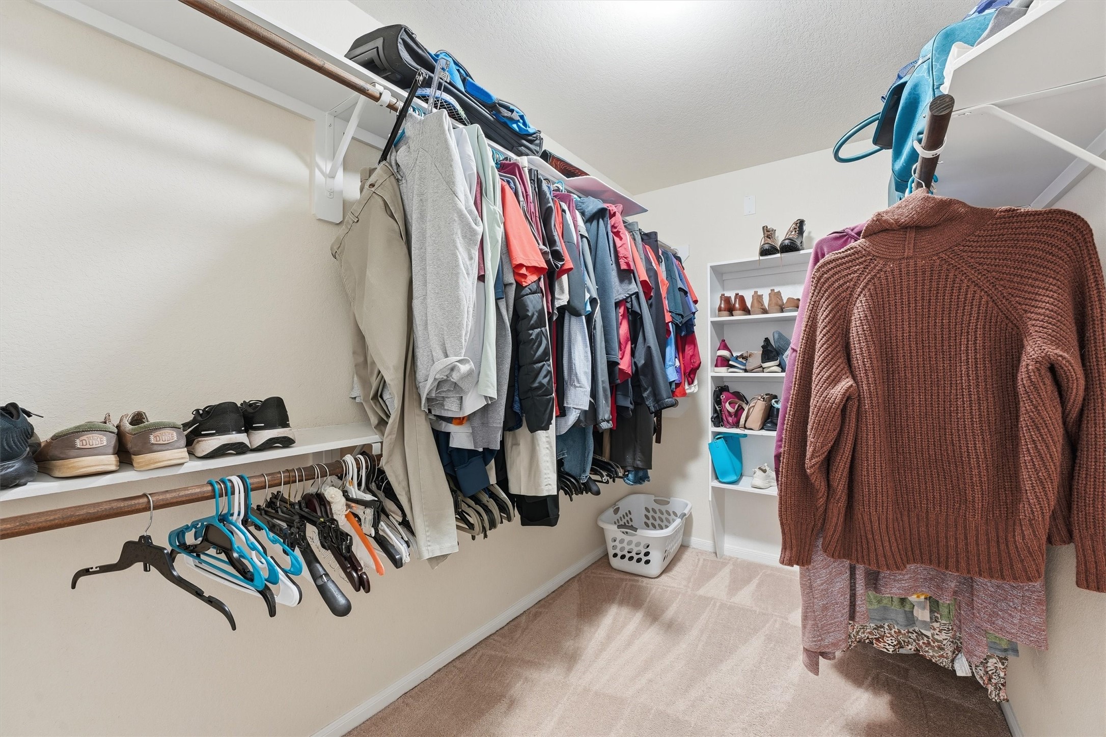 2115 Pacific Loon Lane Conroe, TX 77385 - Photo 18 of 26 a view of walk in closet with clothes and shoes