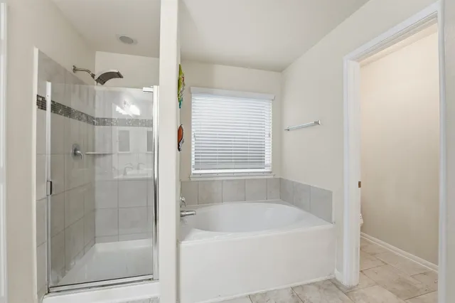 a bathroom with a bathtub and shower