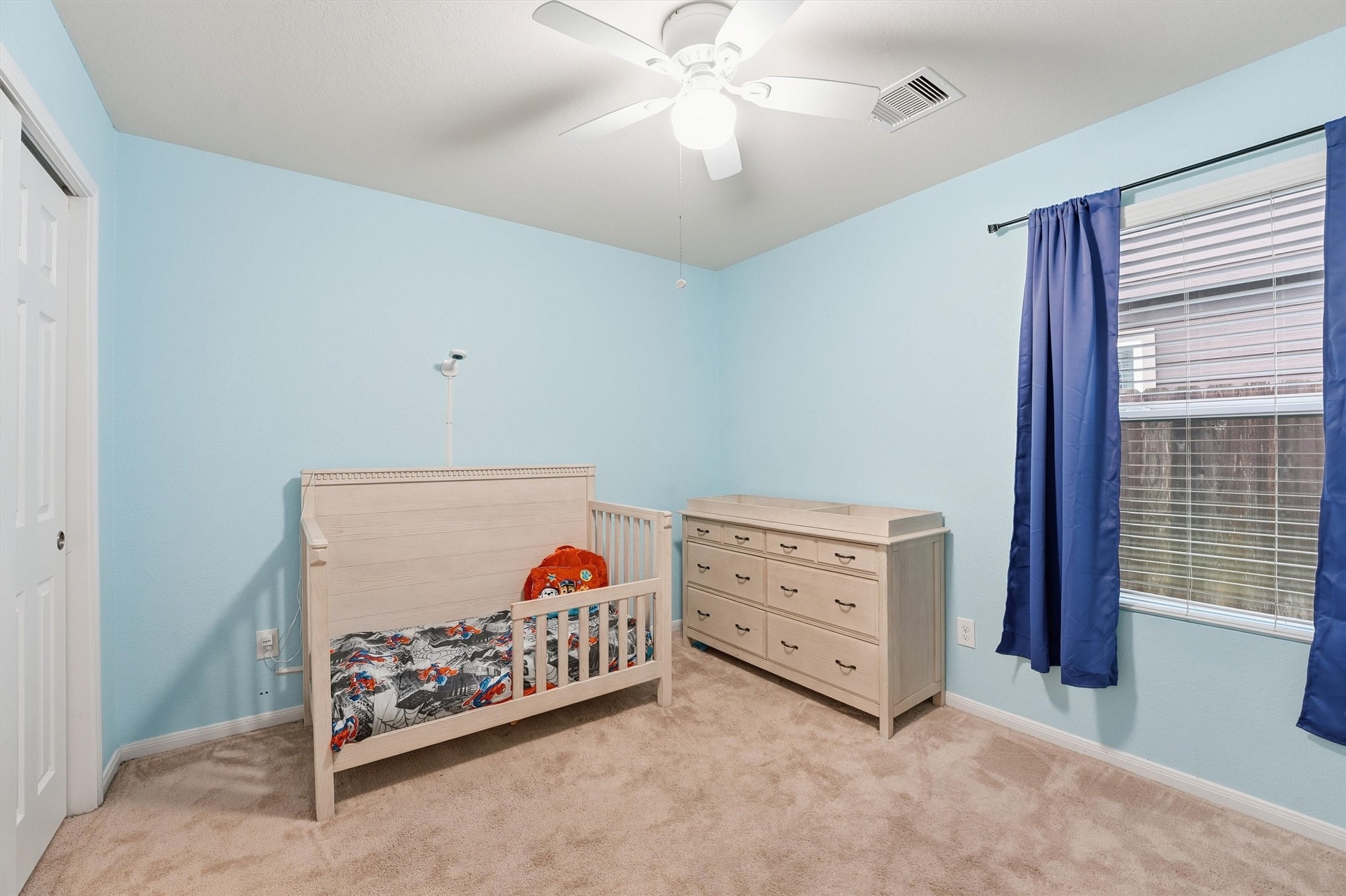 2115 Pacific Loon Lane Conroe, TX 77385 - Photo 20 of 26 a bed room with a bed and a baby crib