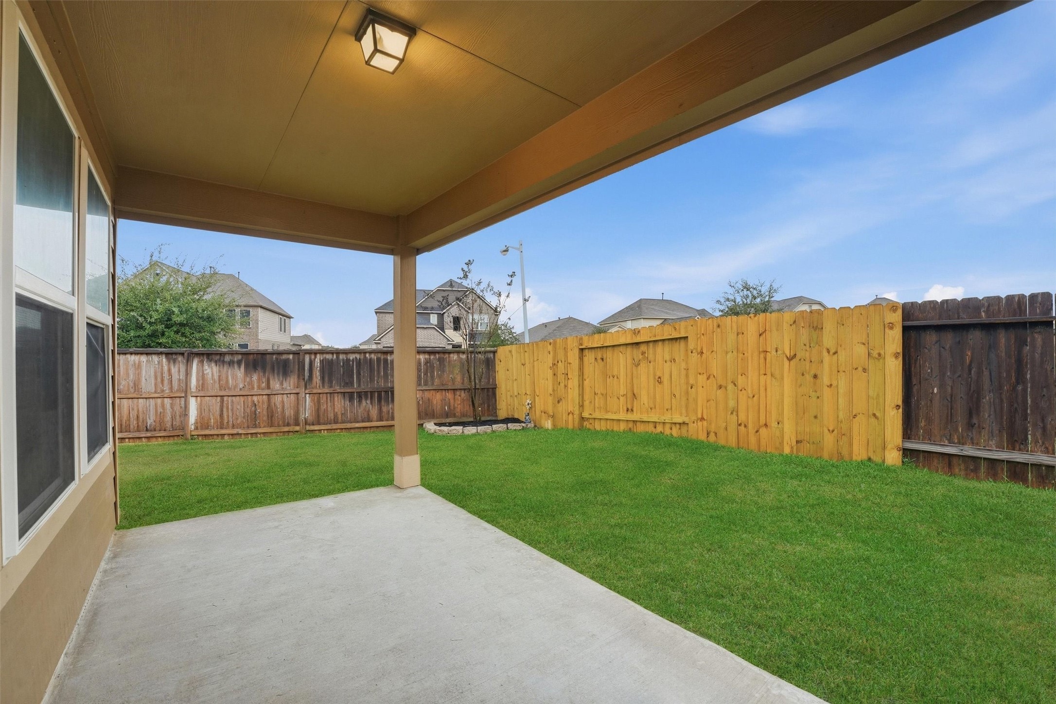 2115 Pacific Loon Lane Conroe, TX 77385 - Photo 23 of 26 a view of a backyard with wooden fence