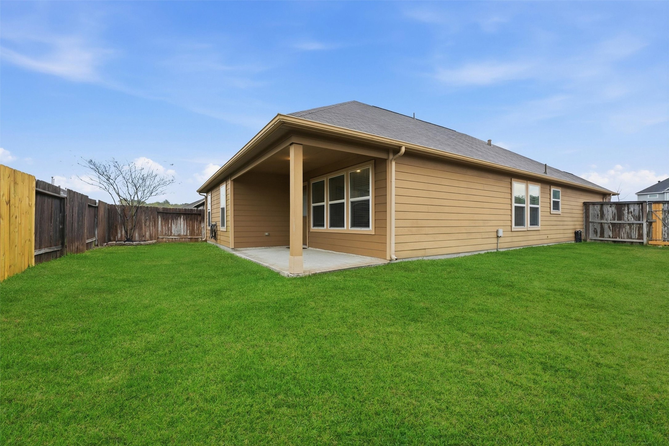 2115 Pacific Loon Lane Conroe, TX 77385 - Photo 25 of 26 a view of a house with a backyard