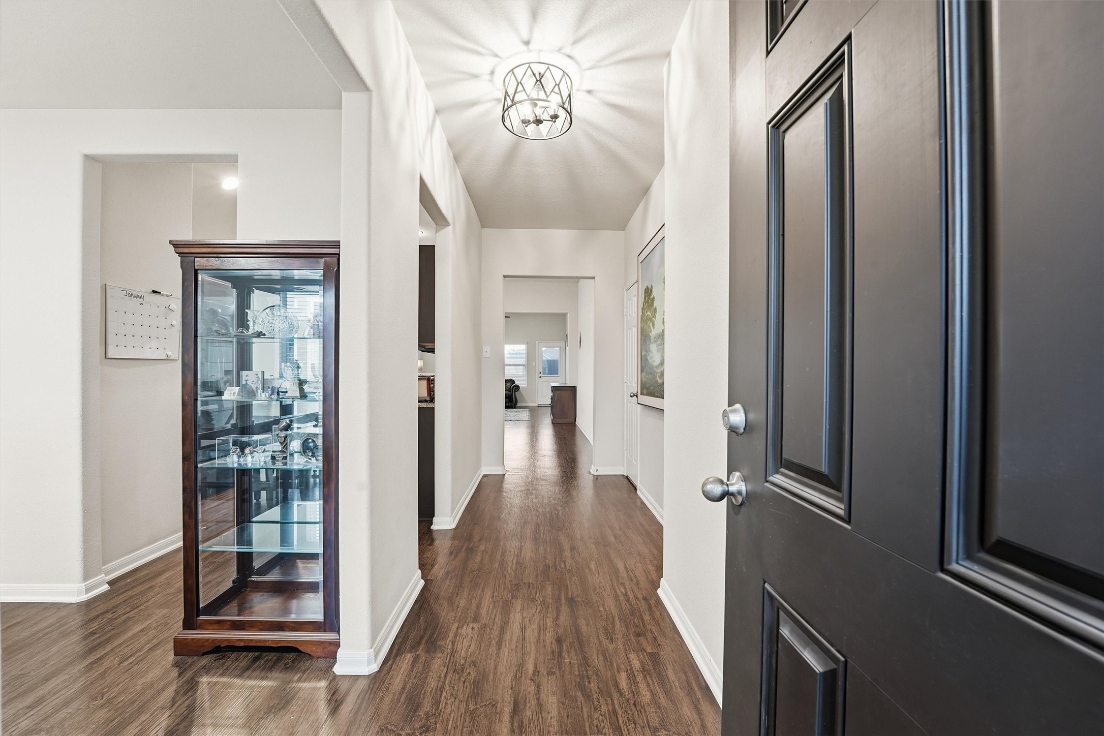 2115 Pacific Loon Lane Conroe, TX 77385 - Photo 4 of 26 a view of a hallway view with wooden floor and staircase