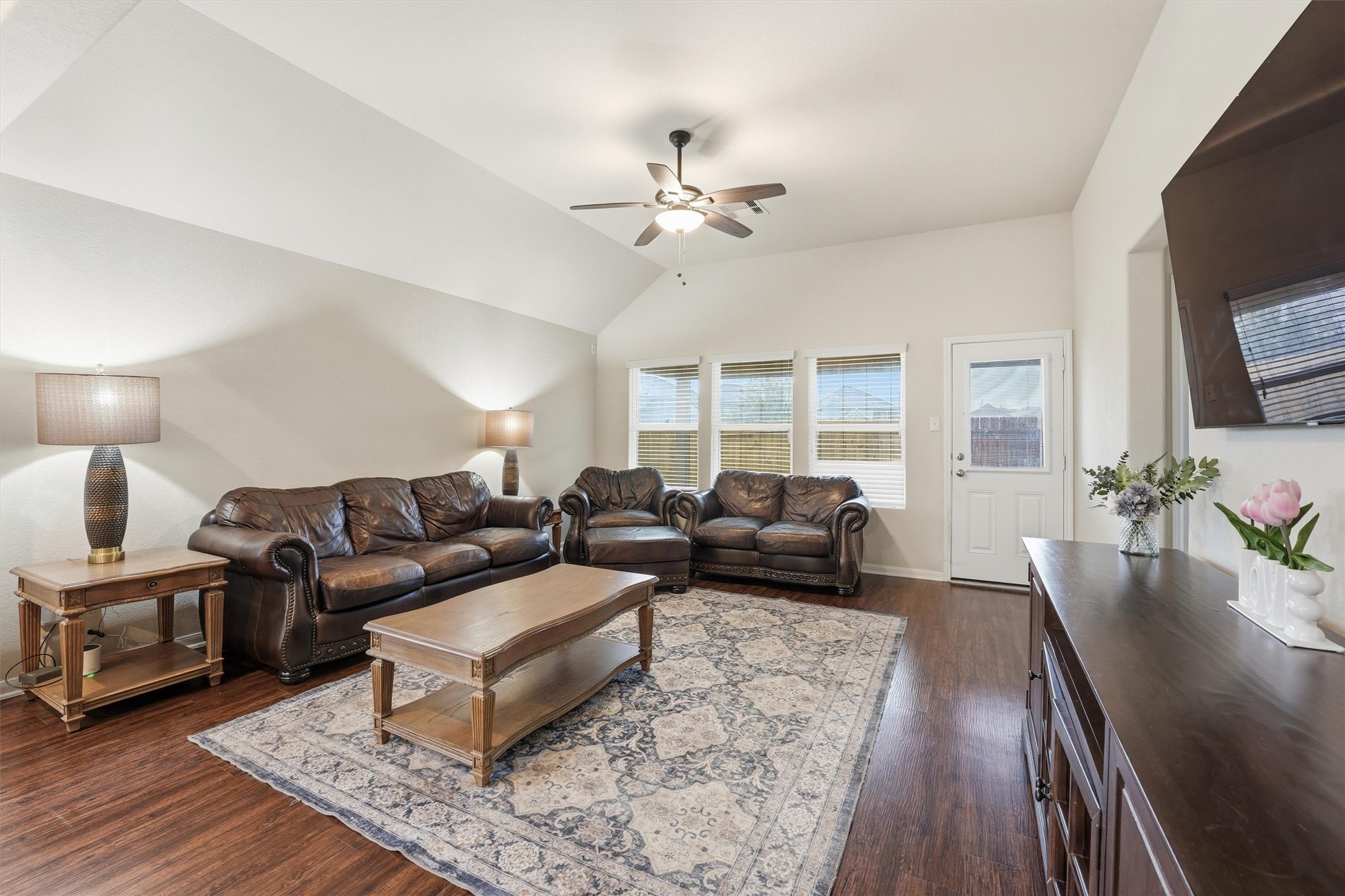 2115 Pacific Loon Lane Conroe, TX 77385 - Photo 6 of 26 a living room with furniture a flat screen tv and a fireplace