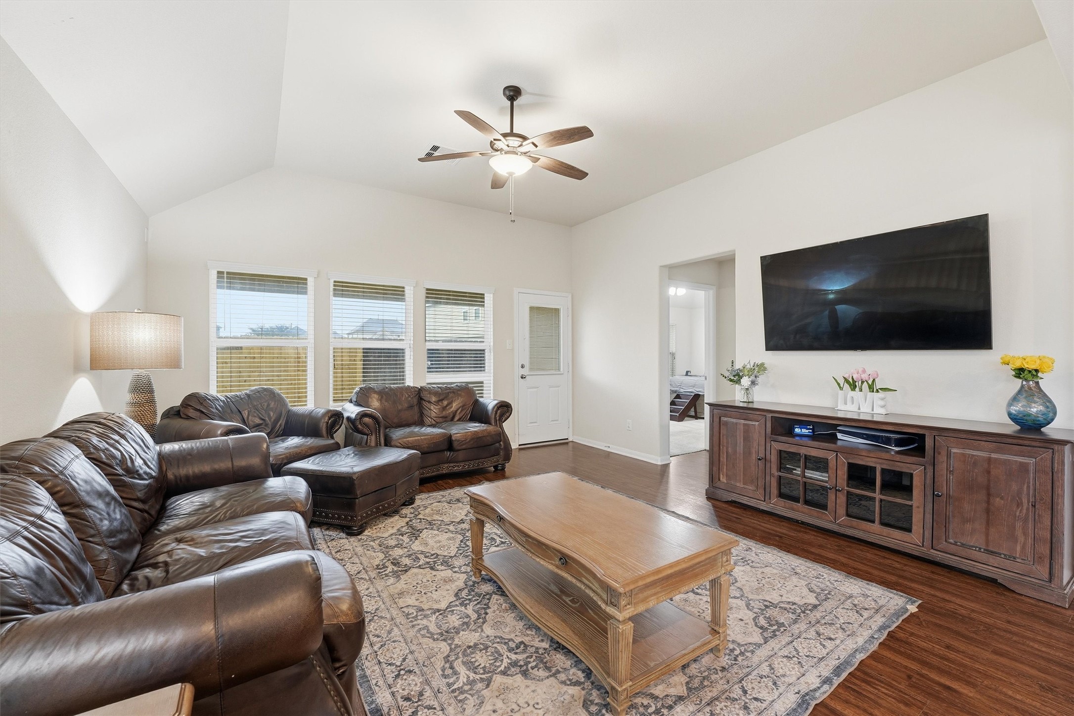 2115 Pacific Loon Lane Conroe, TX 77385 - Photo 7 of 26 a living room with furniture and a flat screen tv