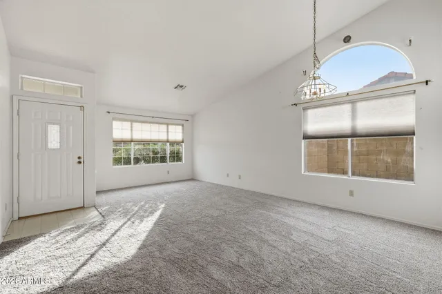 an empty room with windows and closet