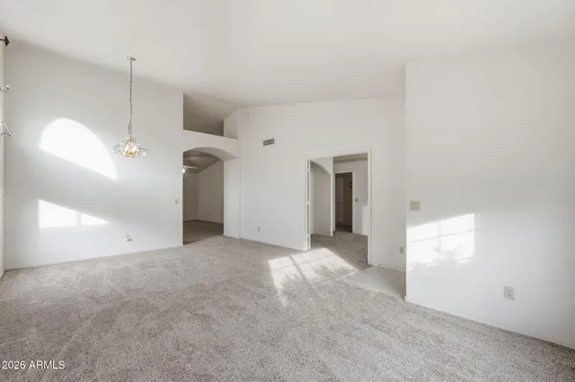 a view of a room with an empty space and a ceiling fan