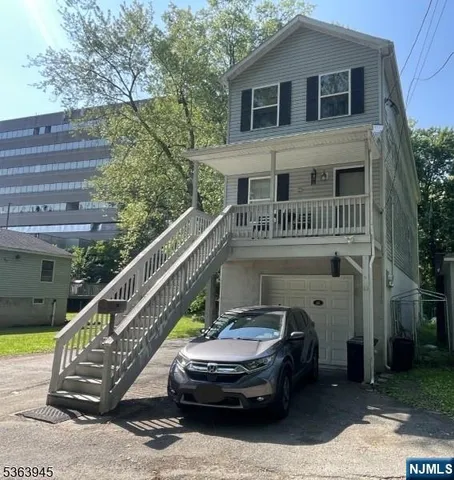 a view of balcony with car parked