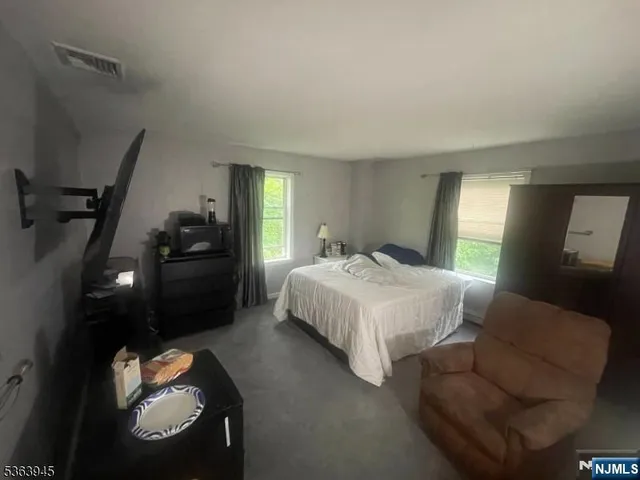 a bedroom with a bed and a mirror