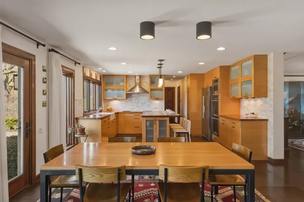 a large kitchen with a table and chairs