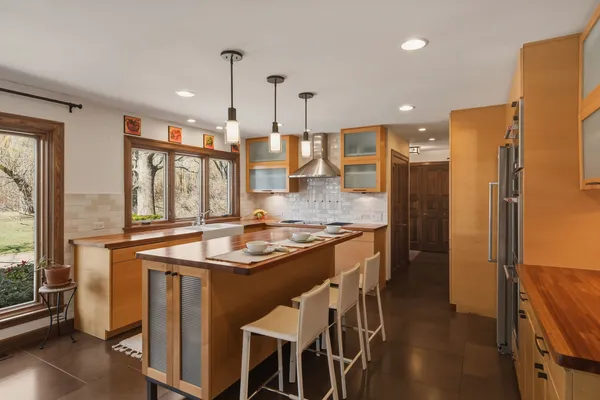 a kitchen with stainless steel appliances granite countertop a stove and refrigerator
