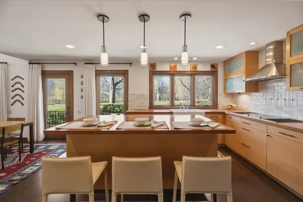 a dining table with chairs and window