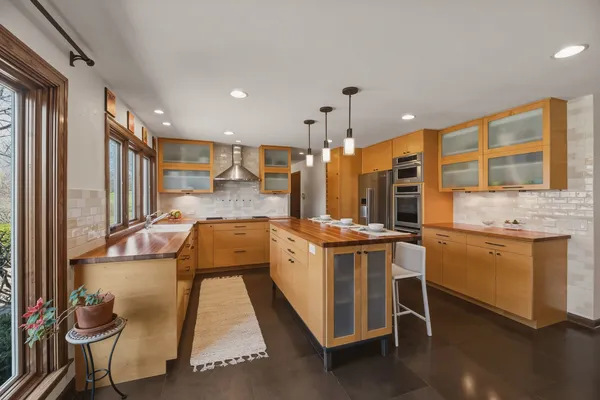 a kitchen with stainless steel appliances granite countertop a stove and cabinets