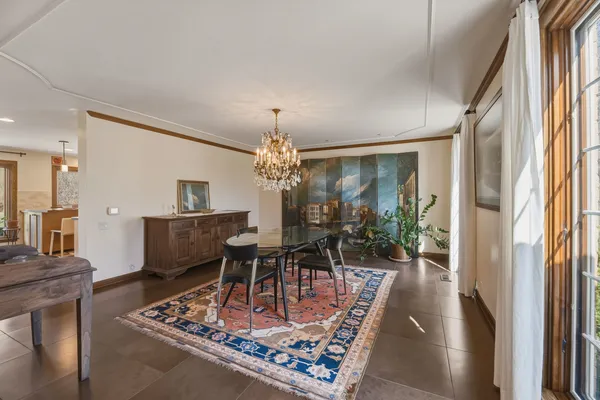 a living room with furniture and a chandelier