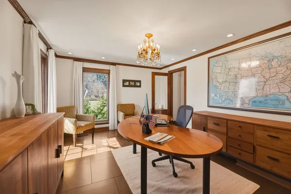 a living room with furniture a table and large windows