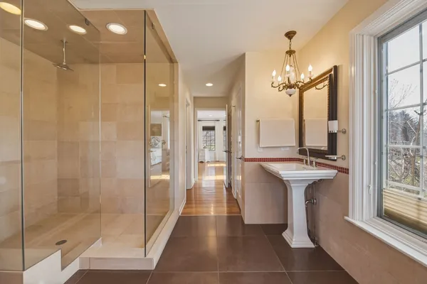 a bathroom with a shower and a sink