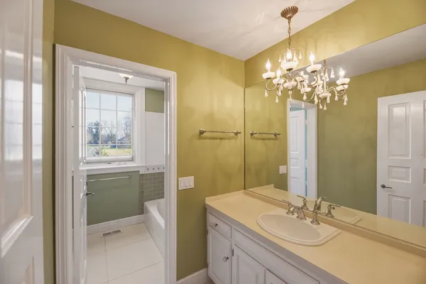 a bathroom with a granite countertop sink a toilet and shower