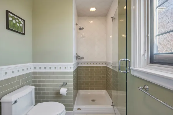 a bathroom with a shower a toilet and a sink
