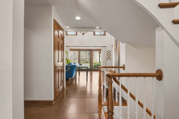a view of a hallway with wooden floor and windows