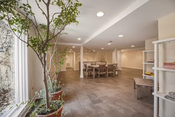 a kitchen with stainless steel appliances dining table and chairs