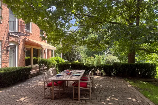 a view of a patio with table and chairs and potted plants