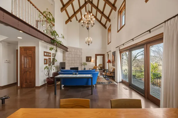a living room with fireplace furniture and a large window