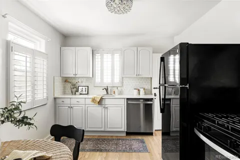 a kitchen with stainless steel appliances granite countertop a refrigerator sink and stove