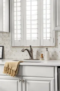 a bathroom with a granite countertop sink and a window