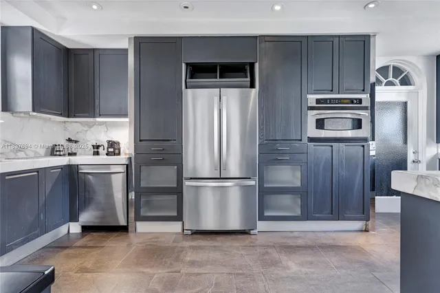 a kitchen with a sink cabinets and window