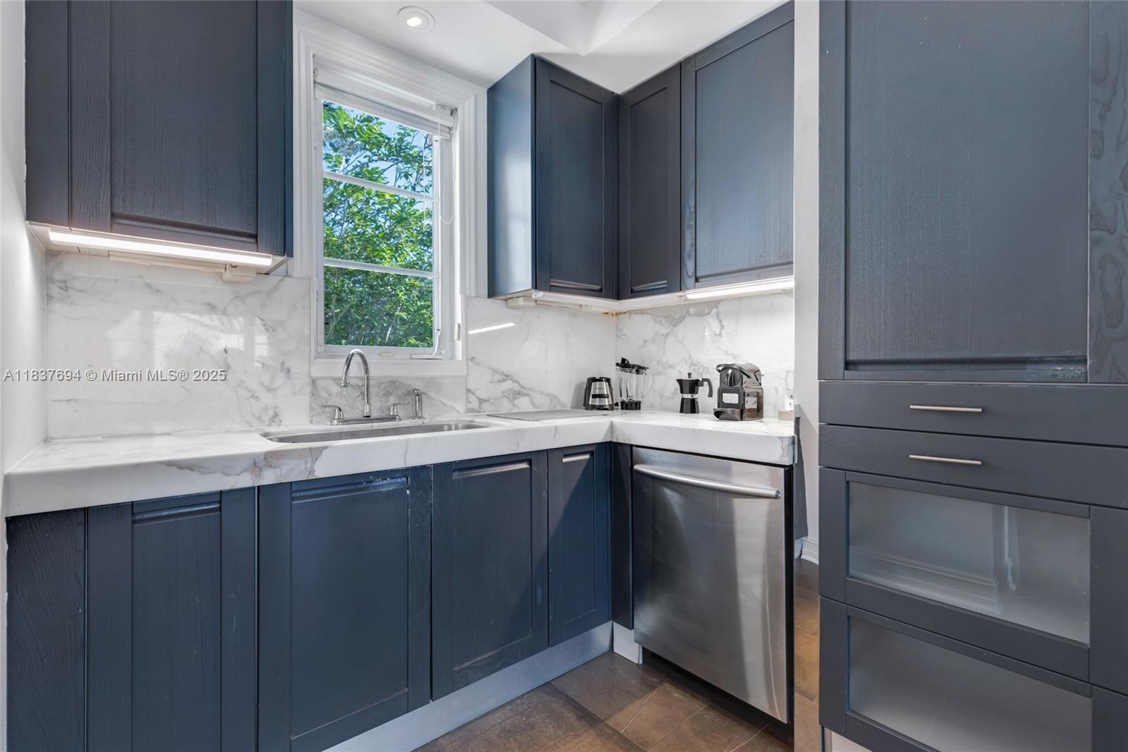 113 Northeast 101st Street Miami Shores, FL 33138 - Photo 16 of 56 a kitchen with a sink cabinets and window