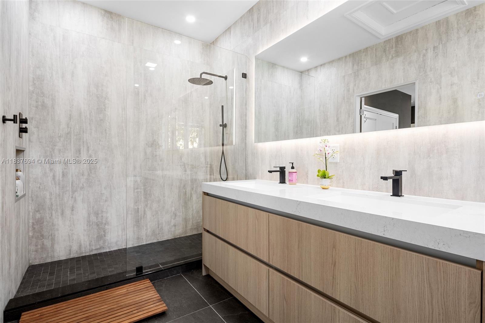 113 Northeast 101st Street Miami Shores, FL 33138 - Photo 24 of 56 a bathroom with a sink and a mirror