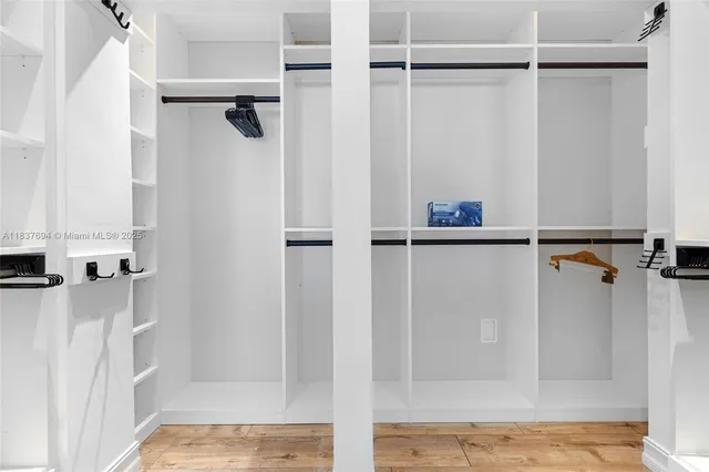 a bed sitting in a bedroom next to a bathroom