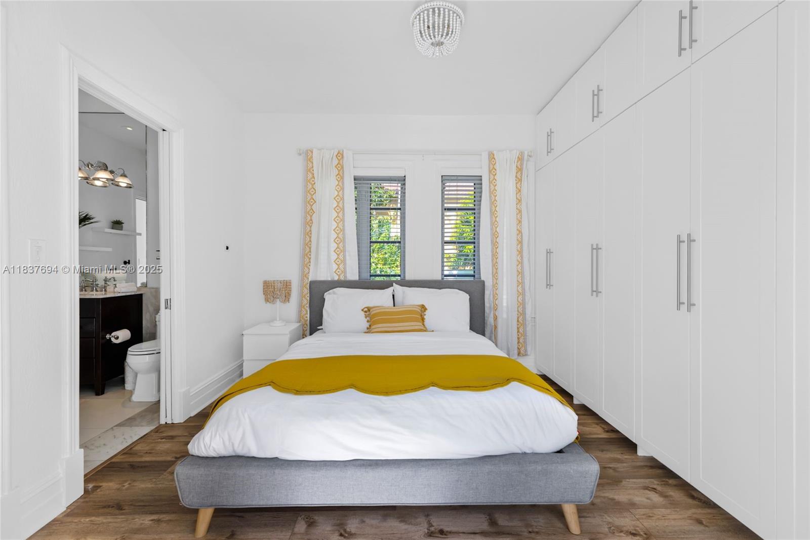 113 Northeast 101st Street Miami Shores, FL 33138 - Photo 26 of 56 a bed sitting in a spacious bedroom next to a window