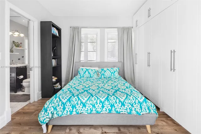 a view of a room with wooden floor and cabinet