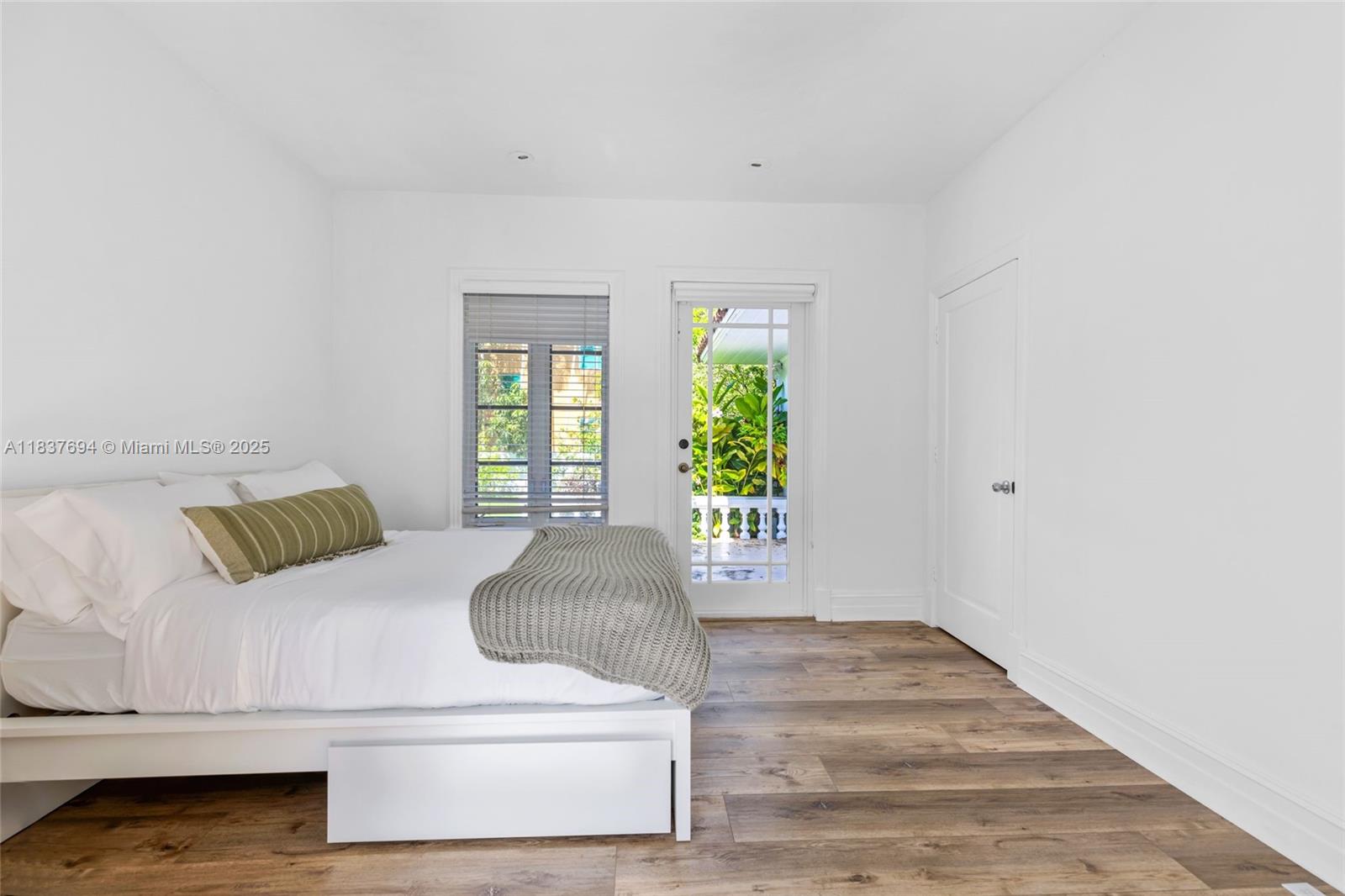 113 Northeast 101st Street Miami Shores, FL 33138 - Photo 34 of 56 a bedroom with a bed and a large window