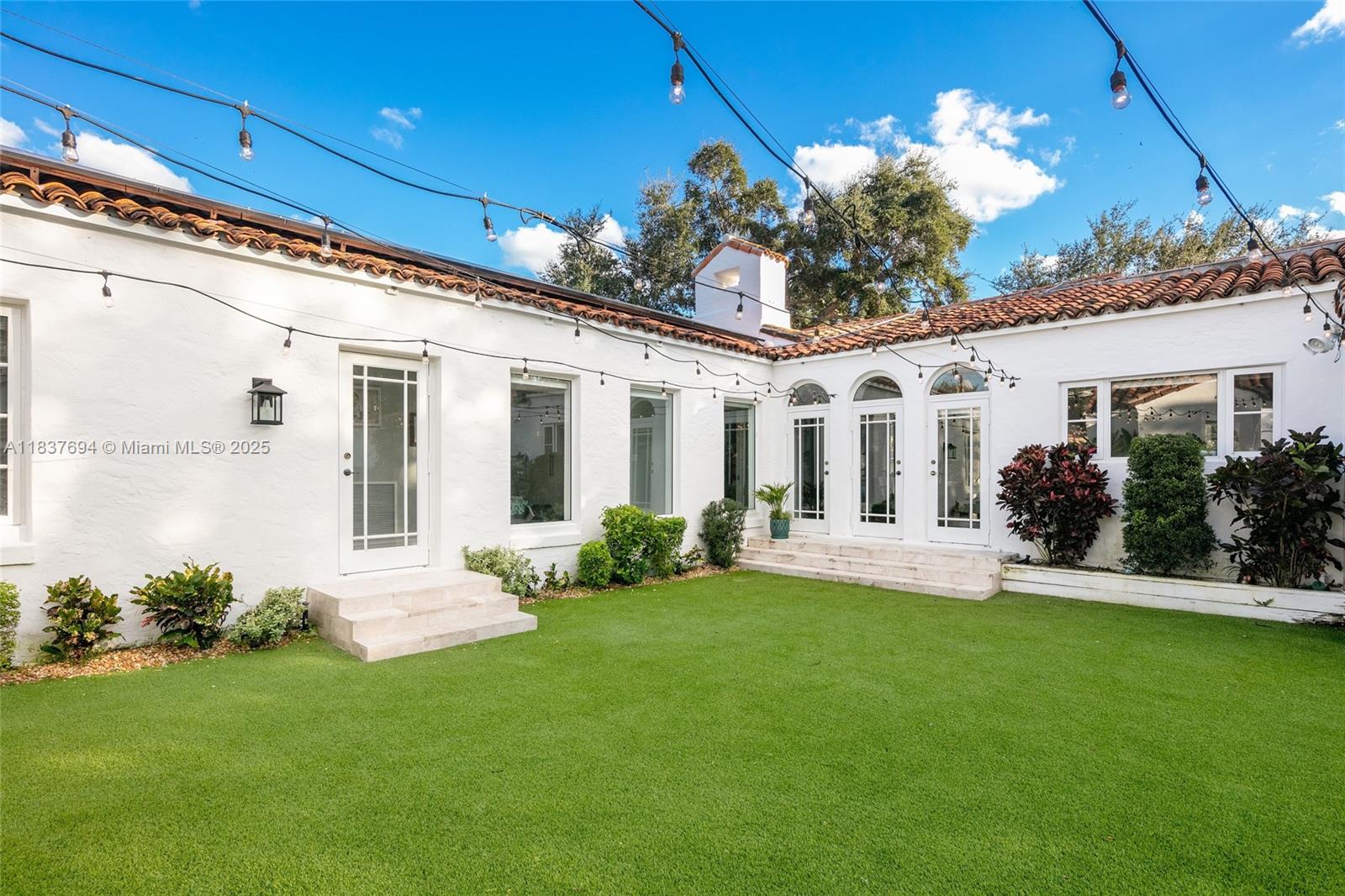 113 Northeast 101st Street Miami Shores, FL 33138 - Photo 36 of 56 a front view of a house with a garden and yard